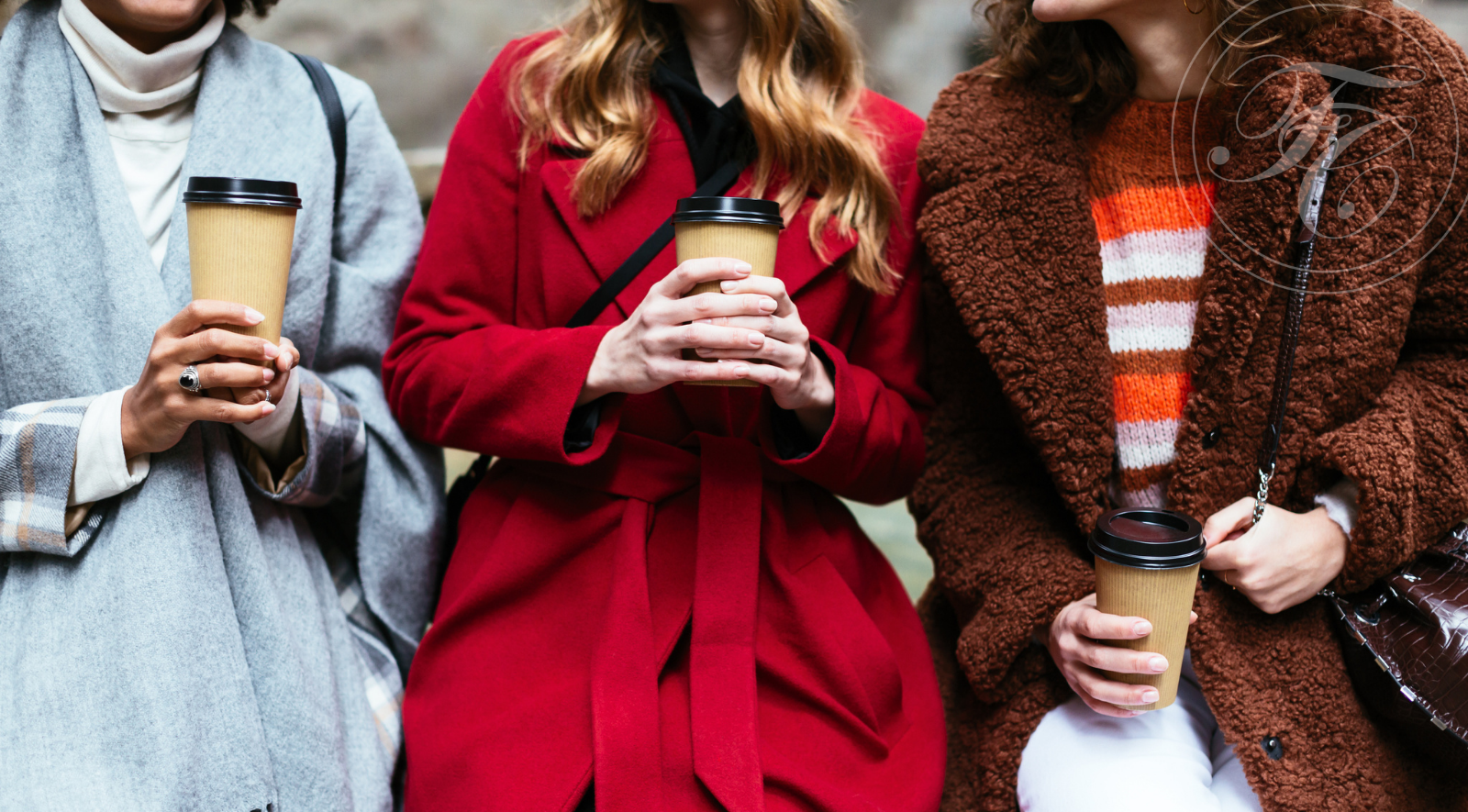 Women in coats with their to go coffees